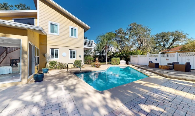 view of pool with fence and a patio