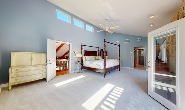 bedroom featuring baseboards, high vaulted ceiling, visible vents, and light colored carpet