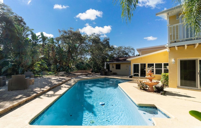 pool featuring a patio area and central AC unit