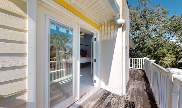 view of exterior entry with a balcony