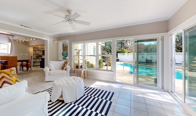 living room featuring ornamental molding, a wealth of natural light, and light tile patterned floors