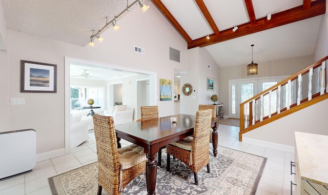 dining space featuring baseboards, visible vents, beam ceiling, and light tile patterned flooring