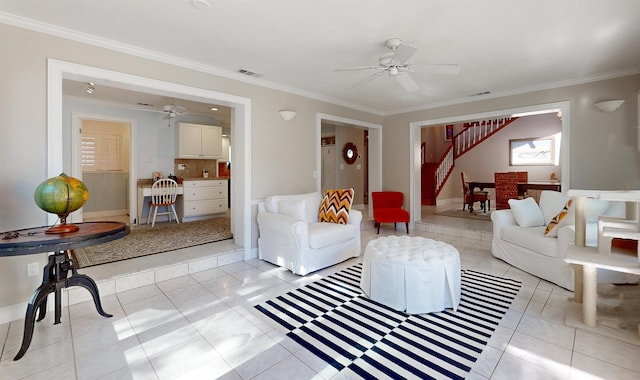 living room featuring ceiling fan, light tile patterned floors, visible vents, and crown molding