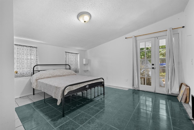 1463 Spring St, Saint Augustine, FL 32084 - bedroom with a textured ceiling, access to exterior, tile patterned flooring, french doors, and lofted ceiling