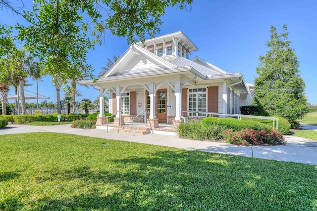 29 Turkey Trot Ct, Saint Augustine, FL 32095 - greek revival house with stone siding, a front yard, and covered porch