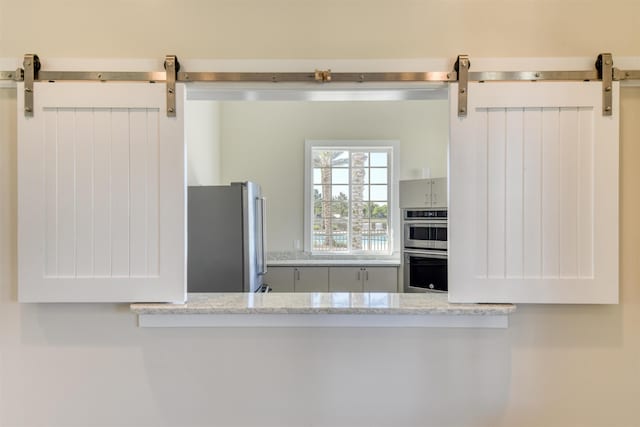 29 Turkey Trot Ct, Saint Augustine, FL 32095 - kitchen with a barn door and appliances with stainless steel finishes