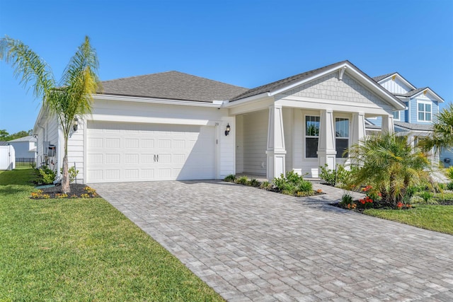 29 Turkey Trot Ct, Saint Augustine, FL 32095 - view of front of home with an attached garage, a porch, a front yard, and decorative driveway