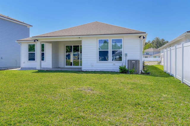 29 Turkey Trot Ct, Saint Augustine, FL 32095 - back of property featuring a lawn, fence, roof with shingles, and cooling unit