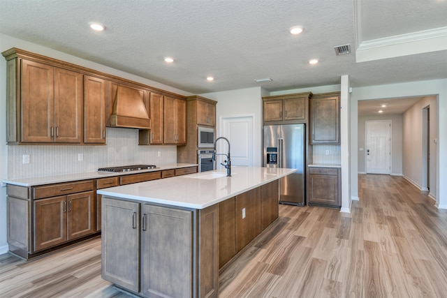 29 Turkey Trot Ct, Saint Augustine, FL 32095 - kitchen featuring premium range hood, decorative backsplash, appliances with stainless steel finishes, and light wood-style flooring