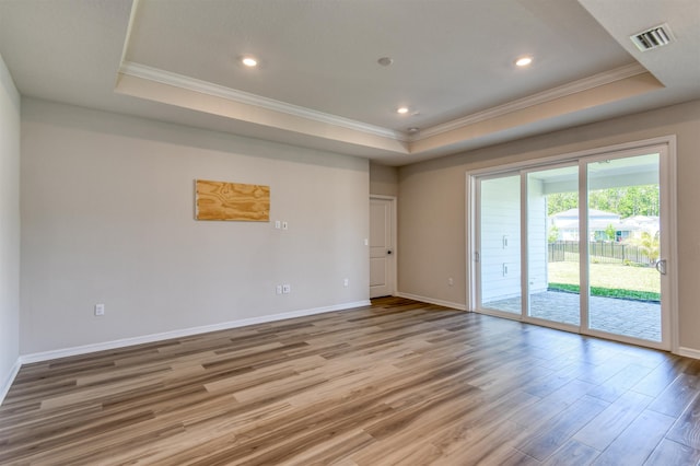 29 Turkey Trot Ct, Saint Augustine, FL 32095 - spare room with crown molding, light wood finished floors, a tray ceiling, and visible vents