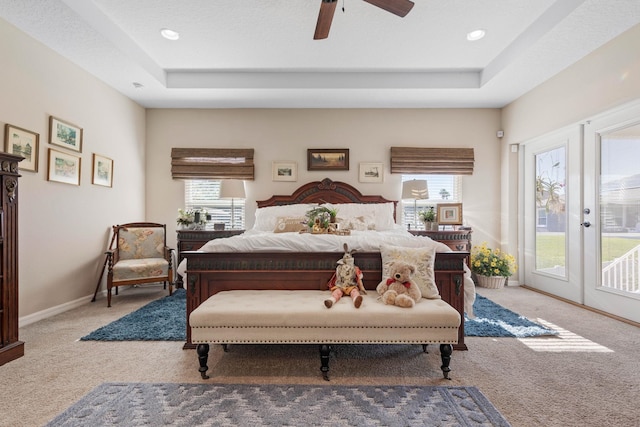 carpeted bedroom featuring access to outside, a raised ceiling, french doors, and baseboards