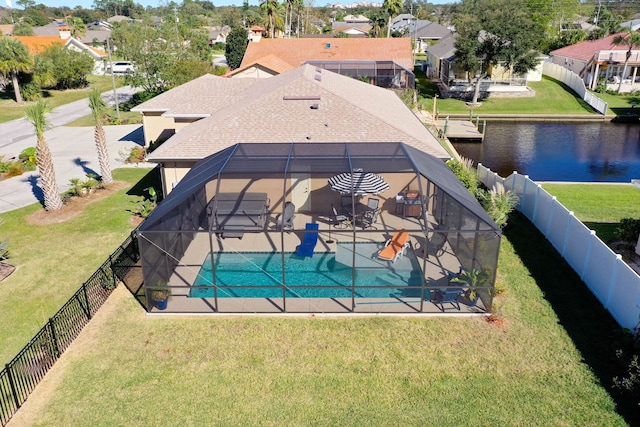 view of swimming pool featuring glass enclosure, a water view, a fenced backyard, and a residential view