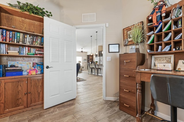 office area featuring light wood-style floors, baseboards, and visible vents