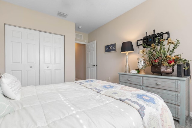 carpeted bedroom with a closet and visible vents