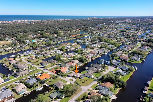 birds eye view of property with a water view and a residential view