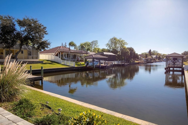 property view of water featuring a dock and fence