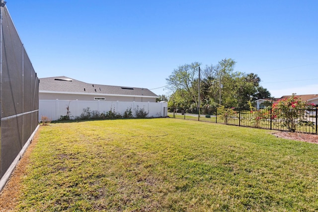 view of yard featuring fence and a lanai