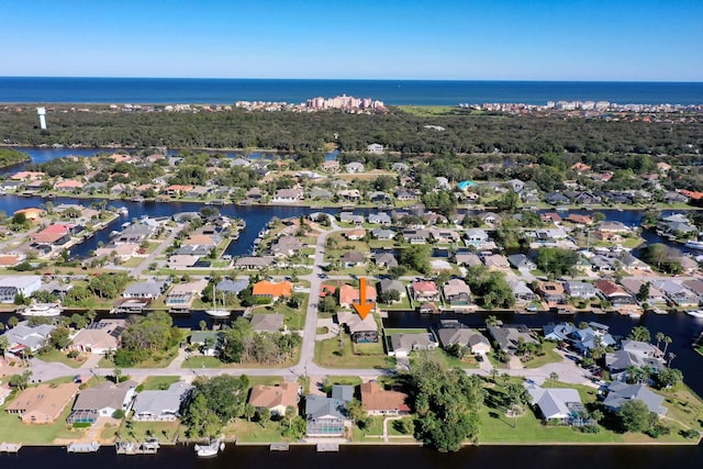 birds eye view of property with a water view and a residential view