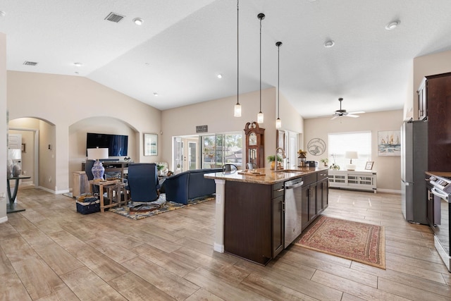 kitchen with appliances with stainless steel finishes, a healthy amount of sunlight, visible vents, and dark brown cabinetry