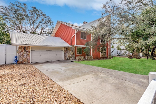 4 Santa Maria Ln, Saint Augustine, FL 32080 - view of front of house with stone siding, concrete driveway, an attached garage, metal roof, and a chimney