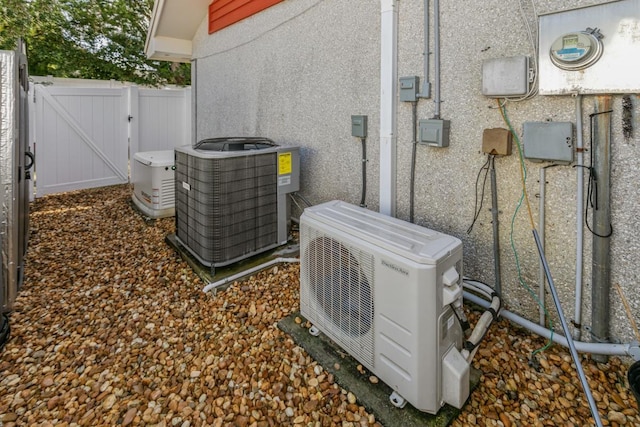 4 Santa Maria Ln, Saint Augustine, FL 32080 - exterior view of a cooling unit, a gate, electric meter, central air condition unit, and stucco siding