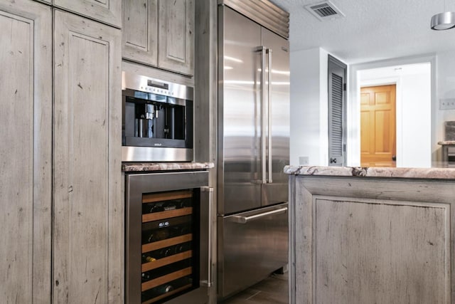 4 Santa Maria Ln, Saint Augustine, FL 32080 - kitchen with built in refrigerator, wine cooler, and a textured ceiling
