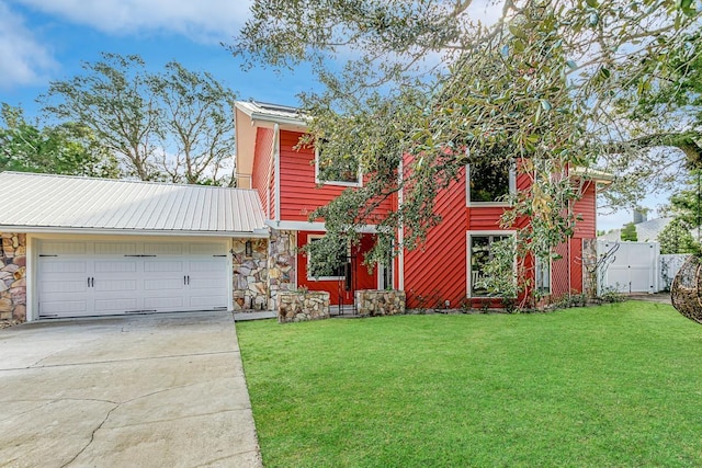 4 Santa Maria Ln, Saint Augustine, FL 32080 - view of front facade with stone siding, concrete driveway, a garage, and metal roof