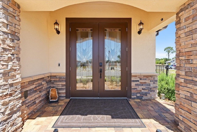 3 Menorca Way, Palm Coast, FL 32137 - view of exterior entry featuring french doors and stucco siding