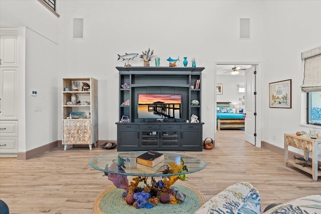 3 Menorca Way, Palm Coast, FL 32137 - living room with a towering ceiling, light wood-style flooring, and a ceiling fan
