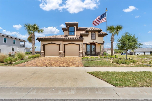 3 Menorca Way, Palm Coast, FL 32137 - mediterranean / spanish house featuring stucco siding, decorative driveway, stone siding, and a tiled roof