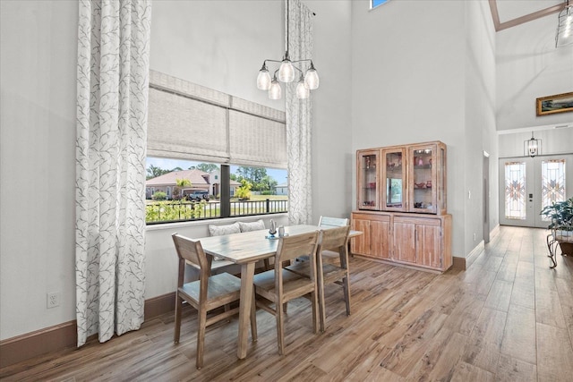 3 Menorca Way, Palm Coast, FL 32137 - dining room featuring a towering ceiling, a chandelier, and wood finished floors
