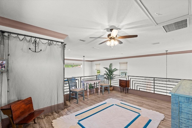 3 Menorca Way, Palm Coast, FL 32137 - sitting room featuring attic access, ceiling fan, wood finished floors, an upstairs landing, and crown molding
