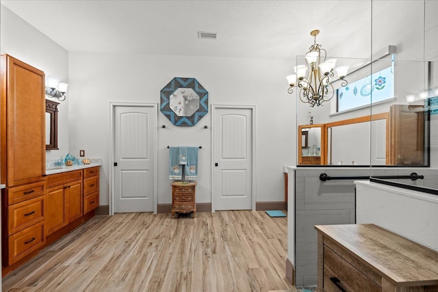3 Menorca Way, Palm Coast, FL 32137 - bathroom with a chandelier, wood finished floors, and vanity