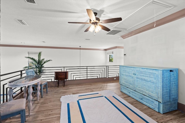 3 Menorca Way, Palm Coast, FL 32137 - sitting room with attic access, ceiling fan, ornamental molding, wood finished floors, and an upstairs landing