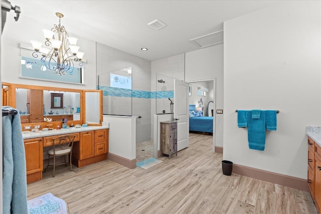3 Menorca Way, Palm Coast, FL 32137 - bathroom with vanity, wood finished floors, ensuite bath, a walk in shower, and a chandelier