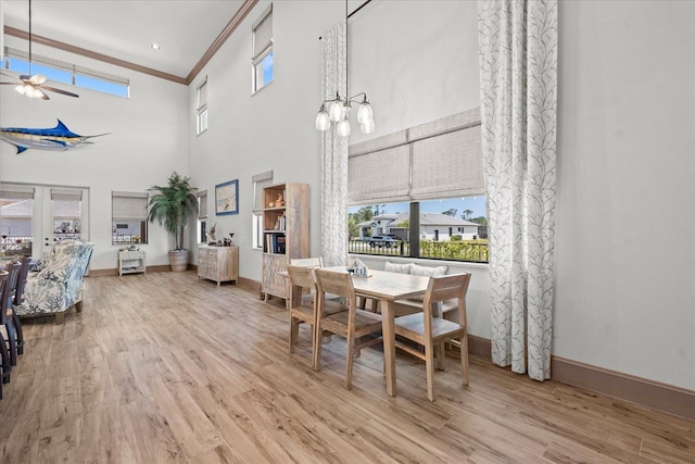 3 Menorca Way, Palm Coast, FL 32137 - dining area featuring ceiling fan, wood finished floors, crown molding, healthy amount of natural light, and a towering ceiling