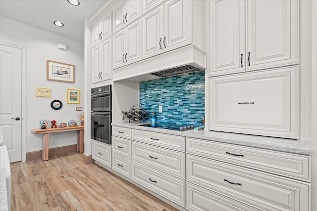 3 Menorca Way, Palm Coast, FL 32137 - kitchen with decorative backsplash, black appliances, white cabinetry, light wood-type flooring, and recessed lighting