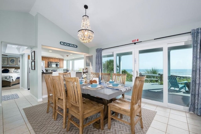 7012 S A1A, Saint Augustine, FL 32080 - dining room featuring light tile patterned floors, vaulted ceiling, a chandelier, and baseboards