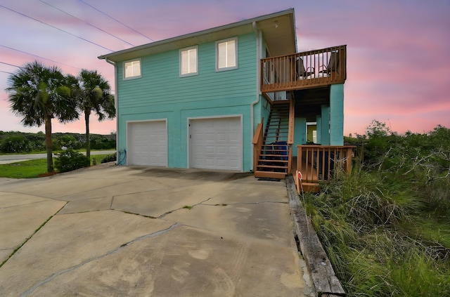 8961 A1A, Saint Augustine, FL 32080 - view of front of home with stairway, an attached garage, driveway, and a deck