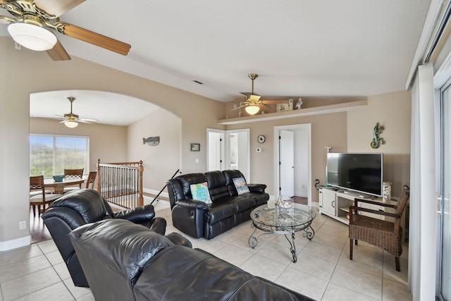 8961 A1A, Saint Augustine, FL 32080 - living room featuring ceiling fan, arched walkways, light tile patterned floors, and vaulted ceiling