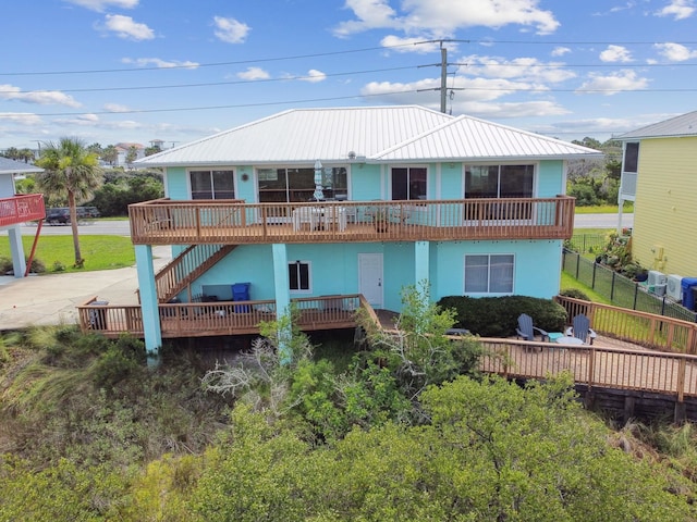 8961 A1A, Saint Augustine, FL 32080 - rear view of house featuring stairway, a deck, a metal roof, and stucco siding