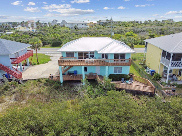 8961 A1A, Saint Augustine, FL 32080 - back of property featuring stairway, a metal roof, and a residential view