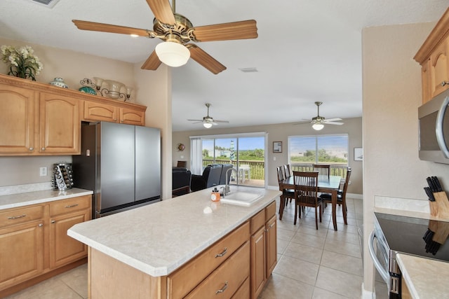 8961 A1A, Saint Augustine, FL 32080 - kitchen with appliances with stainless steel finishes, light countertops, a ceiling fan, light tile patterned floors, and vaulted ceiling