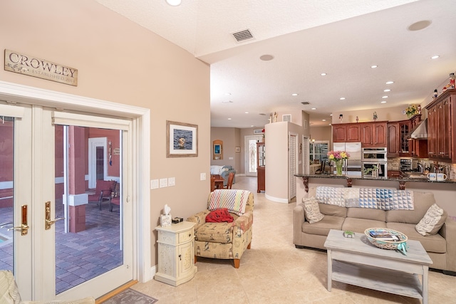 living area featuring light tile patterned flooring, baseboards, visible vents, and recessed lighting