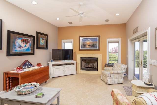 living room featuring light colored carpet, a ceiling fan, recessed lighting, and a fireplace