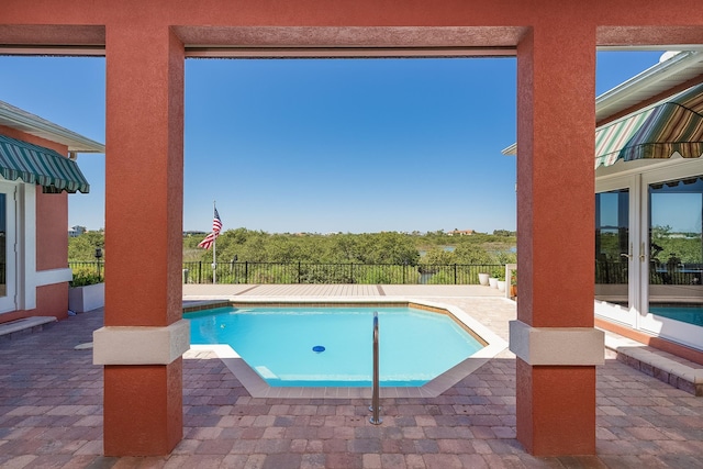 view of pool with a fenced in pool, a patio area, and french doors
