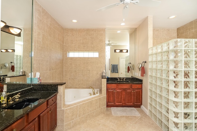 bathroom with ceiling fan, a sink, and a jetted tub