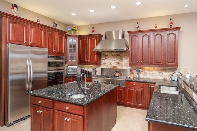 kitchen featuring recessed lighting, a sink, wall chimney exhaust hood, and appliances with stainless steel finishes