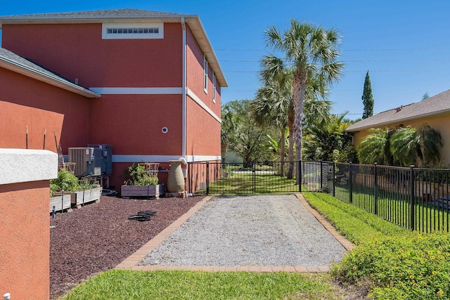 view of yard with central AC and fence