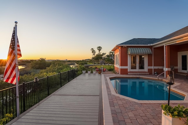view of pool with a fenced in pool, a patio area, and french doors